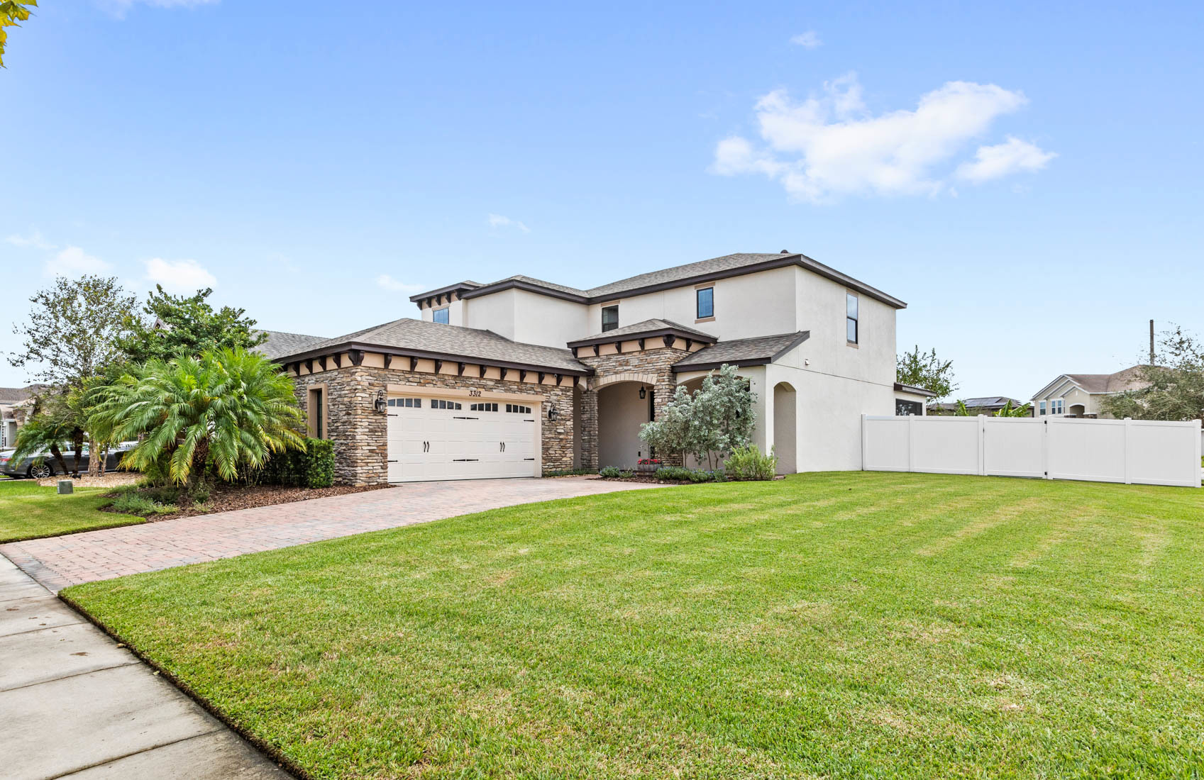 front of two story home with light and dark brown stones