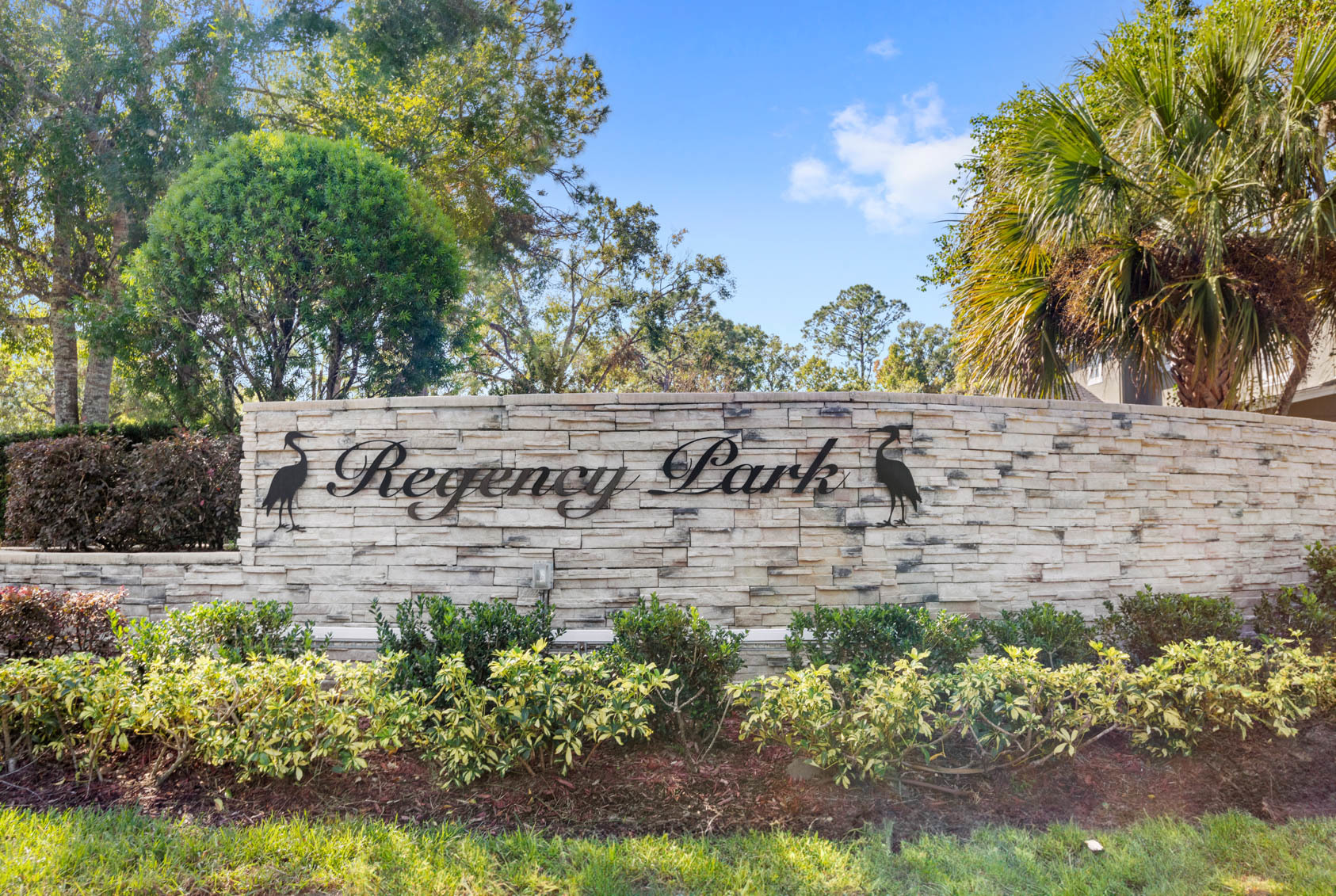 entry sign to regency park with bushes